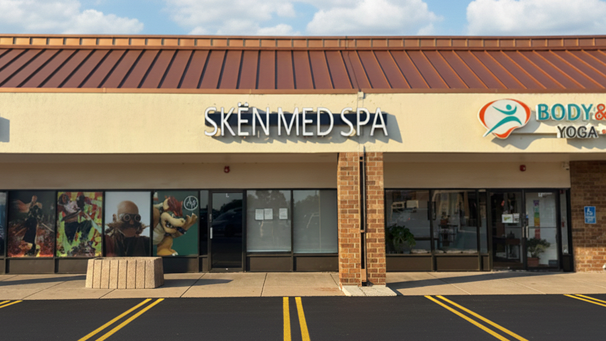SkinMed Spa storefront with Body & Yoga signage in a shopping center with parking lot